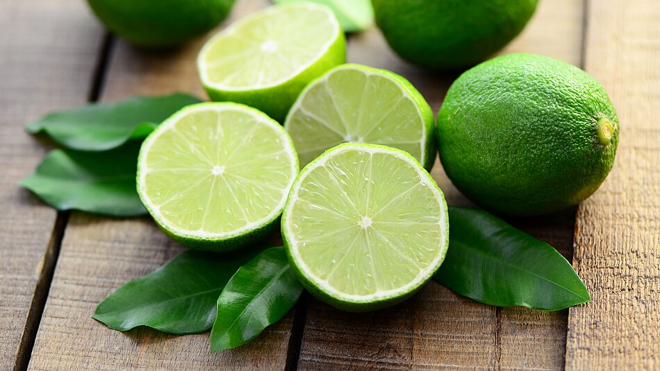 Fresh limes lie on a table